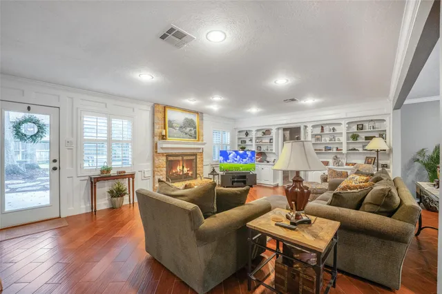 a living room with fireplace furniture and a wooden floor