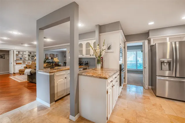 a kitchen with stainless steel appliances granite countertop a refrigerator and a sink