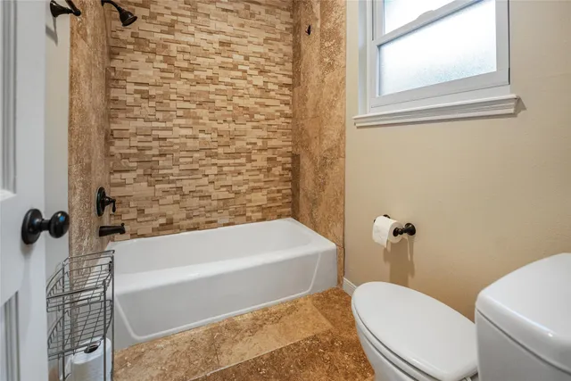 a bathroom with a sink a toilet and bathtub