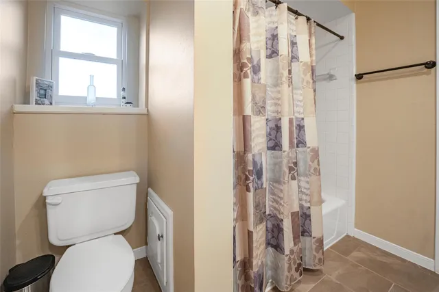 a white toilet sitting next to a bathroom sink