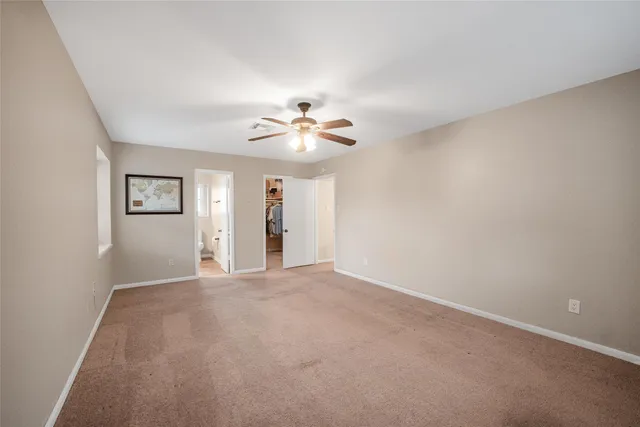 a view of a room with window and ceiling fan