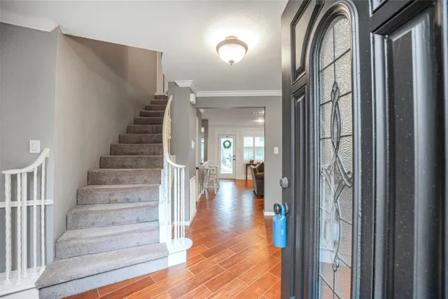 a view of staircase with wooden floor and a window