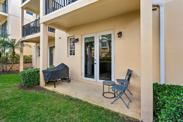 a view of a backyard with furniture and garden