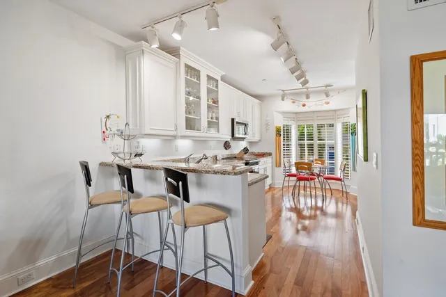 a view of a dining room with furniture and wooden floor