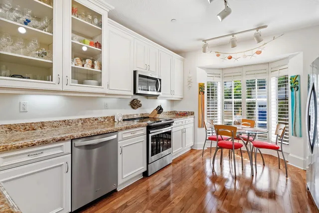 a kitchen with a stove a sink and a refrigerator