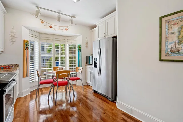 a view of a room with furniture large windows and wooden floor
