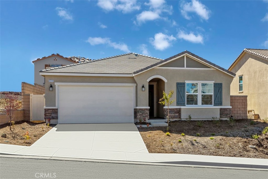 45141 Kingbird Ln Lake Lake Elsinore, CA 92532 - Photo 1 of 1 a front view of a house with garden