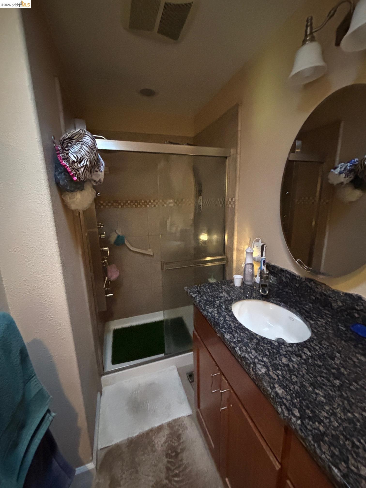 20728 Point View Drive Groveland, CA 95321 - Photo 23 of 45 a bathroom with a granite countertop sink a mirror and shower
