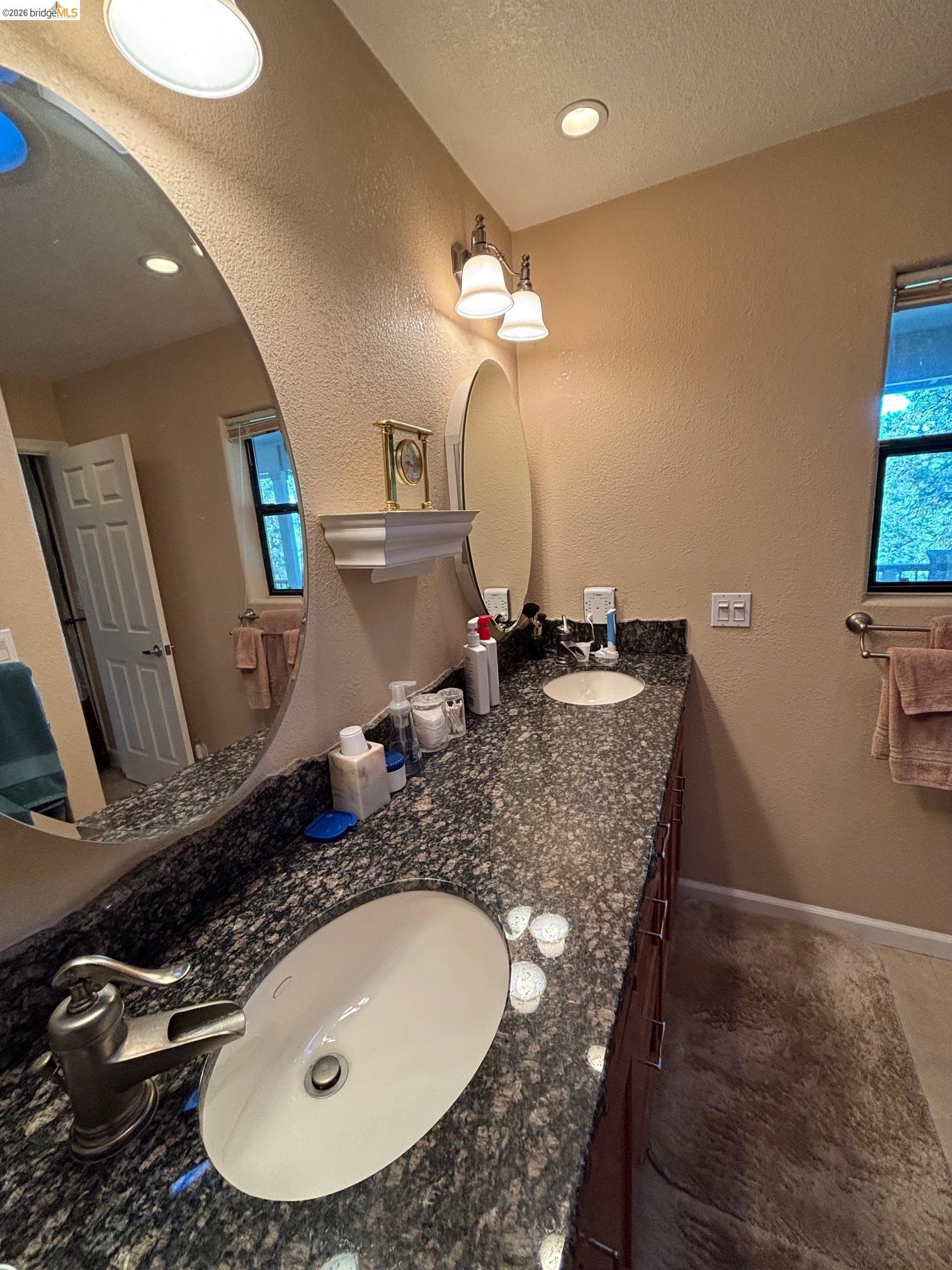 20728 Point View Drive Groveland, CA 95321 - Photo 33 of 45 a bathroom with a granite countertop sink a mirror and vanity
