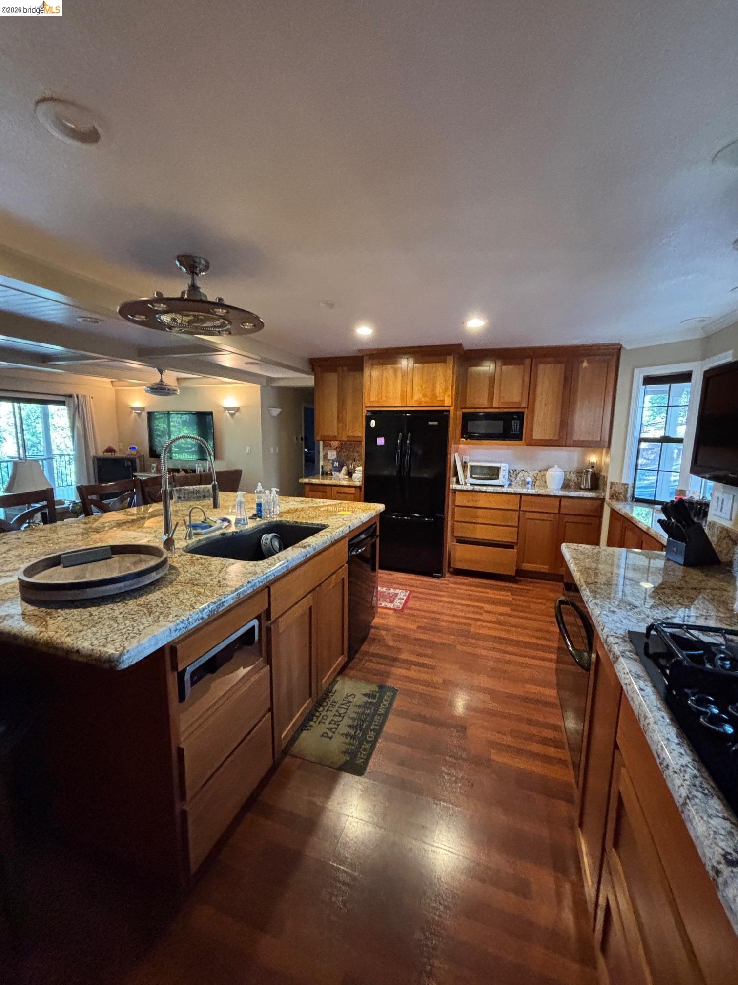 20728 Point View Drive Groveland, CA 95321 - Photo 6 of 45 a kitchen with stainless steel appliances granite countertop a stove top oven a sink a counter space and cabinets