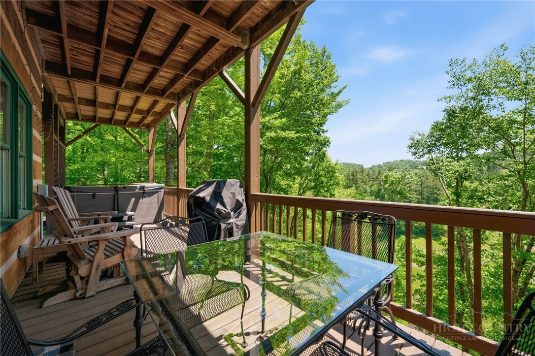 850 River Ridge Road Boone, NC 28607 - Photo 22 of 26 a view of a patio with a table chairs and a backyard