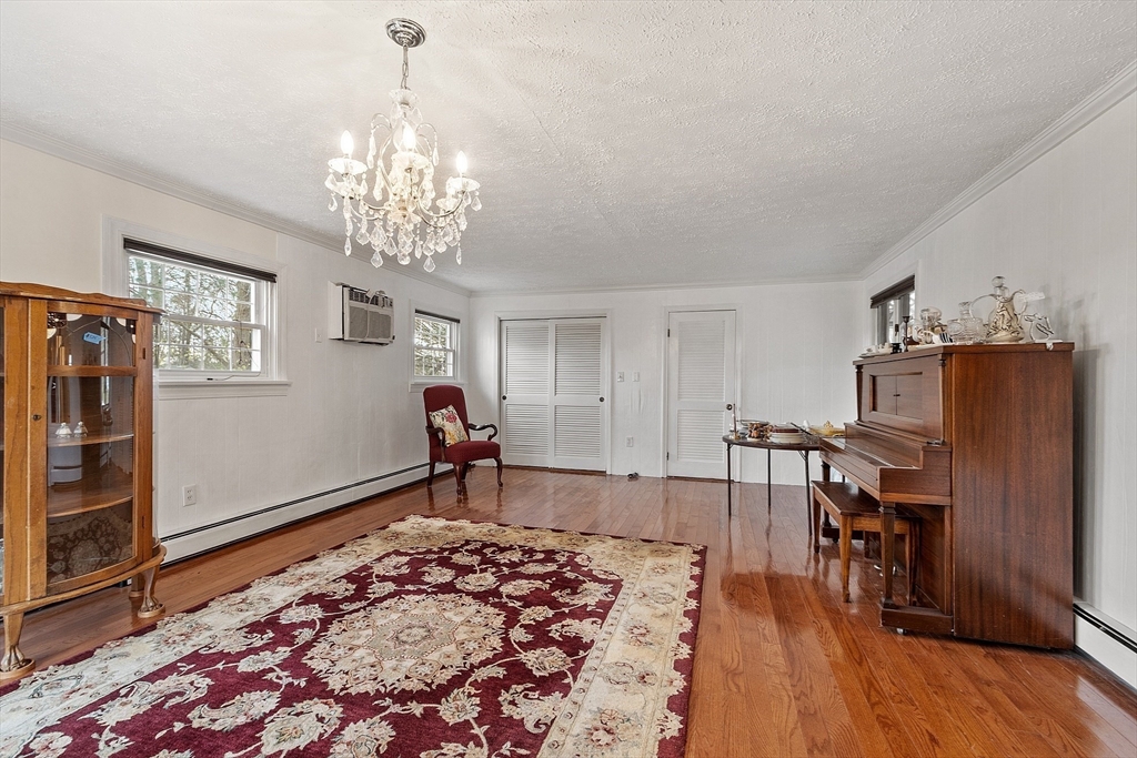 5 Sherman Avenue Haverhill, MA 01832 - Photo 5 of 26 a bedroom with furniture and a chandelier