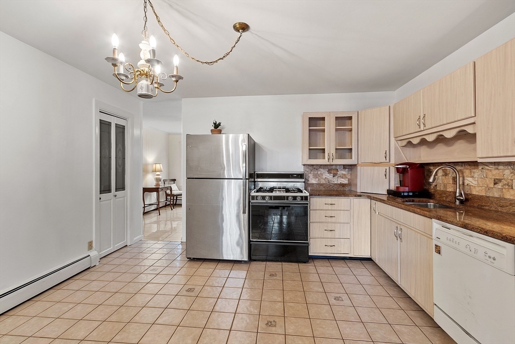 5 Sherman Avenue Haverhill, MA 01832 - Photo 9 of 26 a kitchen with stainless steel appliances granite countertop a refrigerator sink and cabinets