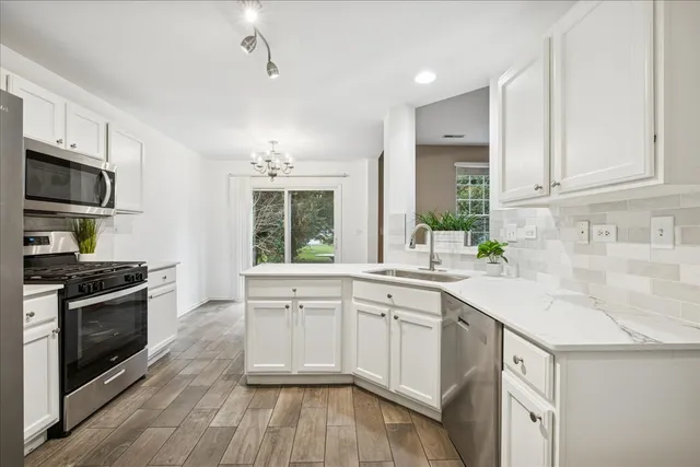 a kitchen with a sink stove and cabinets