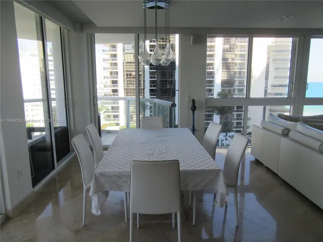 a large kitchen with a table and chairs