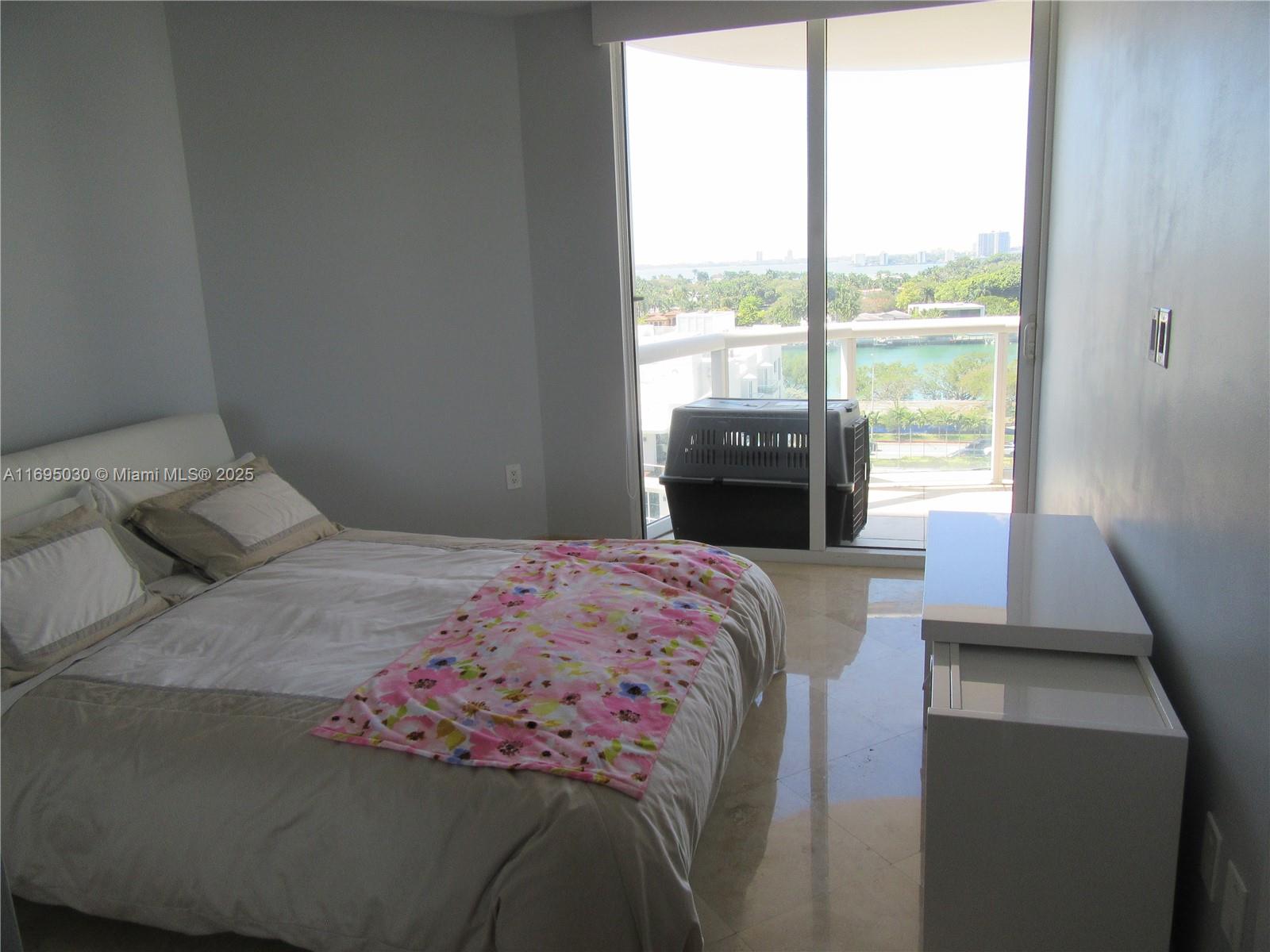 6365 Collins Avenue, Unit 1008 Miami Beach, FL 33141 - Photo 24 of 49 a bedroom with a bed and a window