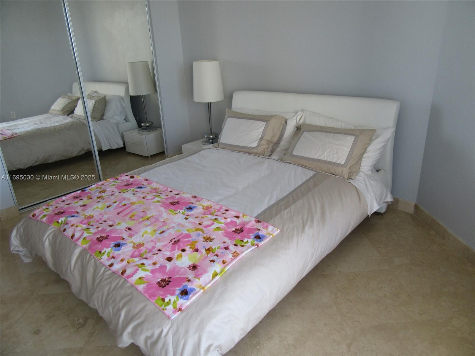 6365 Collins Avenue, Unit 1008 Miami Beach, FL 33141 - Photo 26 of 49 a bedroom with a bed and a couch