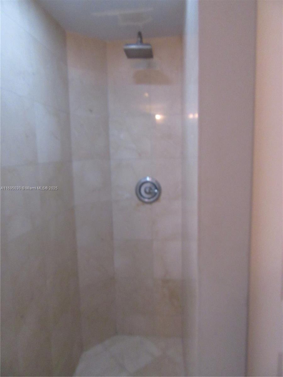 6365 Collins Avenue, Unit 1008 Miami Beach, FL 33141 - Photo 28 of 49 a bathroom with a shower