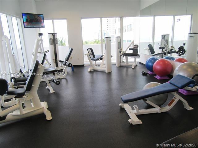 6365 Collins Avenue, Unit 1008 Miami Beach, FL 33141 - Photo 36 of 49 a view of a room with gym equipment