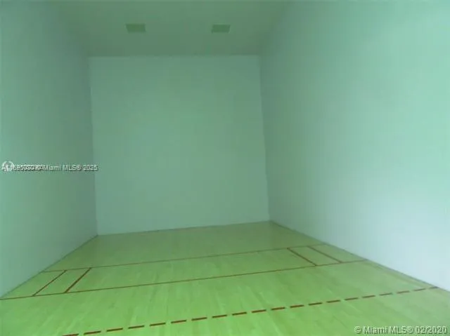 a view of an empty room with wooden cabinet