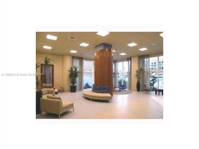 6365 Collins Avenue, Unit 1008 Miami Beach, FL 33141 - Photo 40 of 49 a lobby with furniture and floor to ceiling window