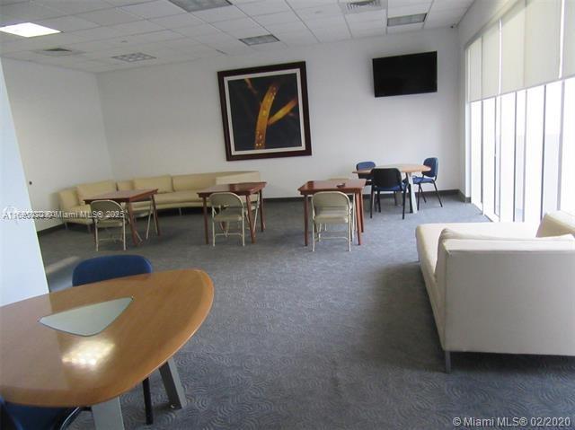 6365 Collins Avenue, Unit 1008 Miami Beach, FL 33141 - Photo 44 of 49 a living room with furniture a flat screen tv and a large window