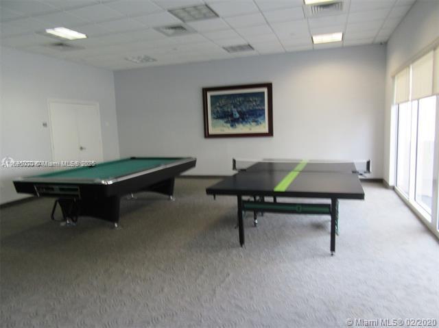 6365 Collins Avenue, Unit 1008 Miami Beach, FL 33141 - Photo 45 of 49 a living room with furniture pool table and windows