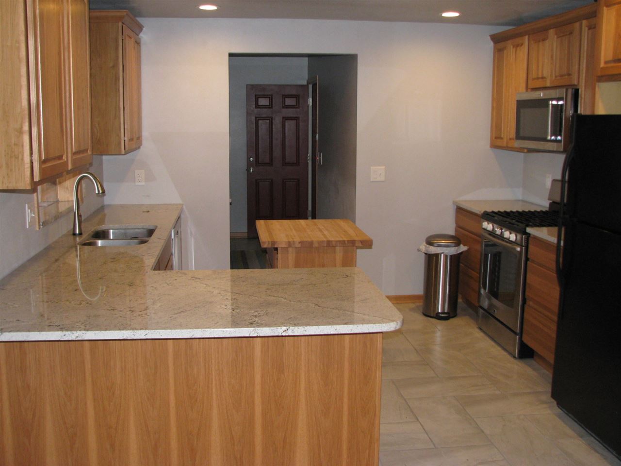 1152 Middle Road South Beloit, IL 61080 - Photo 14 of 24 a kitchen with stainless steel appliances granite countertop a sink a stove and a refrigerator