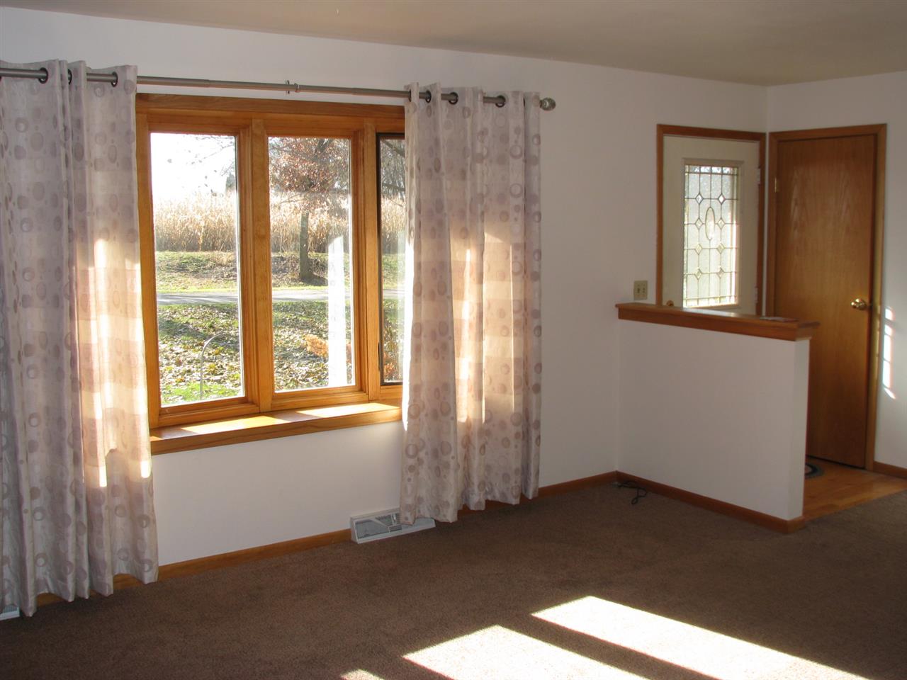 1152 Middle Road South Beloit, IL 61080 - Photo 4 of 24 a view of an empty room with wooden floor and a window