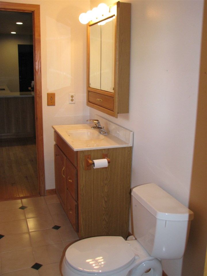 1152 Middle Road South Beloit, IL 61080 - Photo 9 of 24 a bathroom with a granite countertop toilet sink and mirror