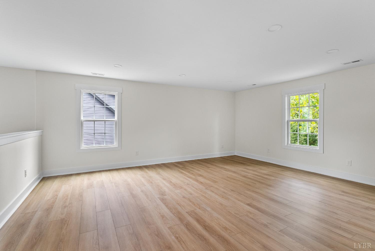 6 Wirtz Road Wirtz, VA 24184 - Photo 27 of 56 an empty room with wooden floor and windows