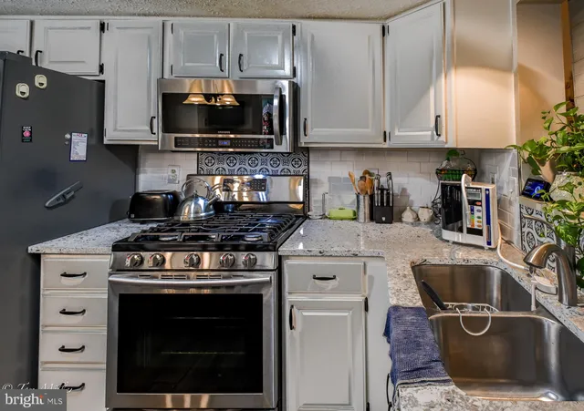 a kitchen with a stove and a microwave