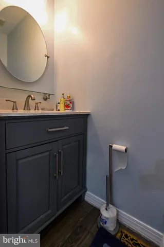 a bathroom with a sink mirror and vanity