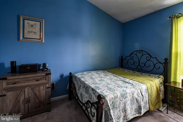 a bedroom with a bed and a desk in it