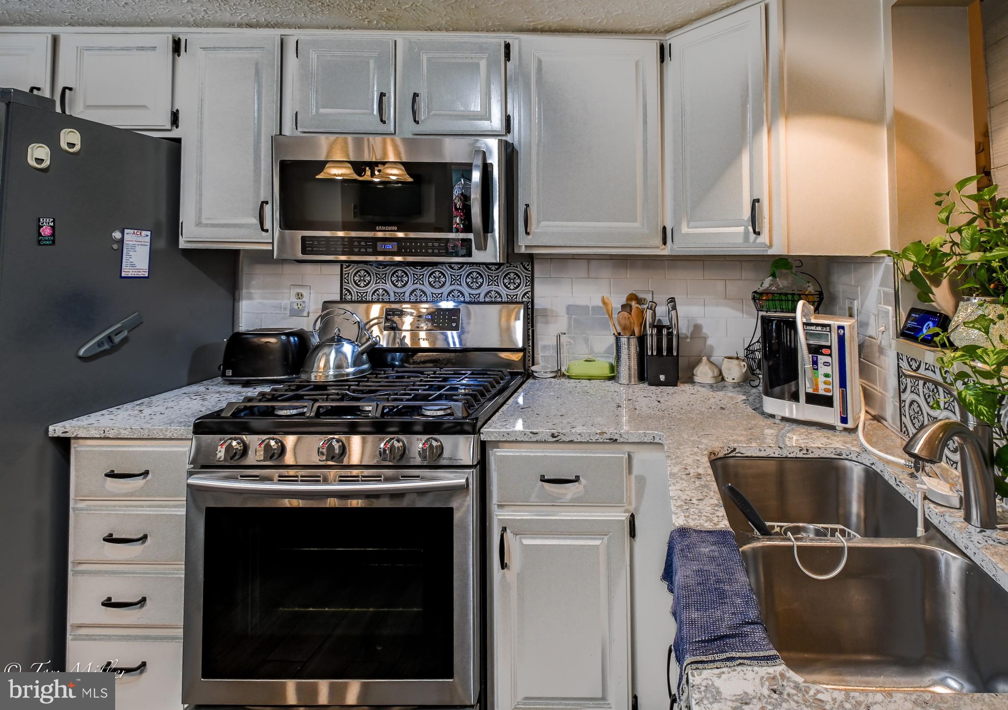 21 Cedarcone Court Nottingham, MD 21236 - Photo 5 of 38 a kitchen with a stove and a microwave
