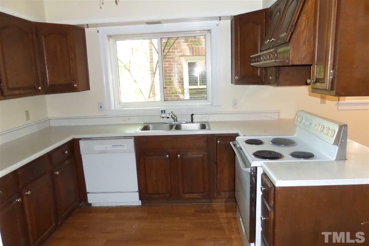 1102 East Martin Street Raleigh, NC 27610 - Photo 11 of 21 a kitchen with a sink stove and cabinets