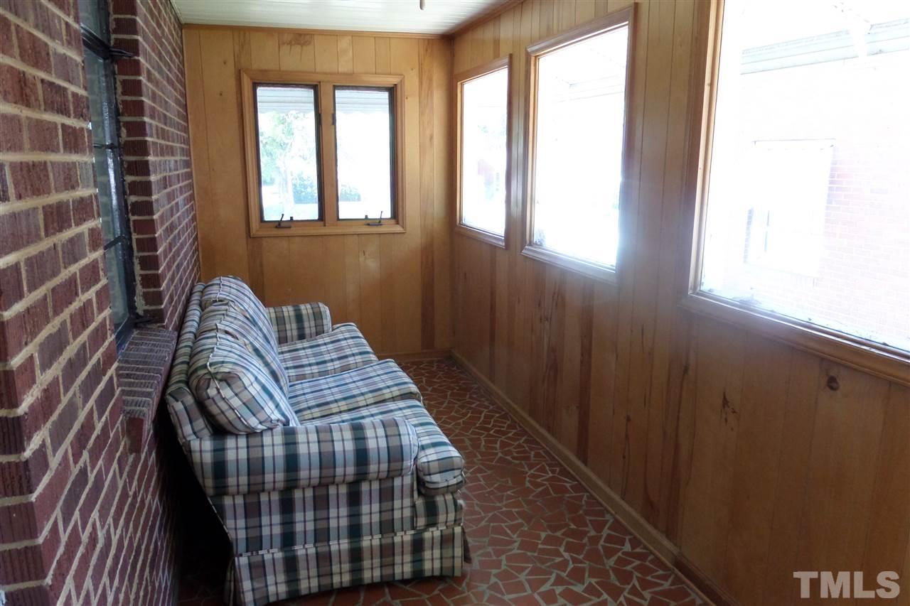1102 East Martin Street Raleigh, NC 27610 - Photo 14 of 21 a bedroom with a bed and wooden floor