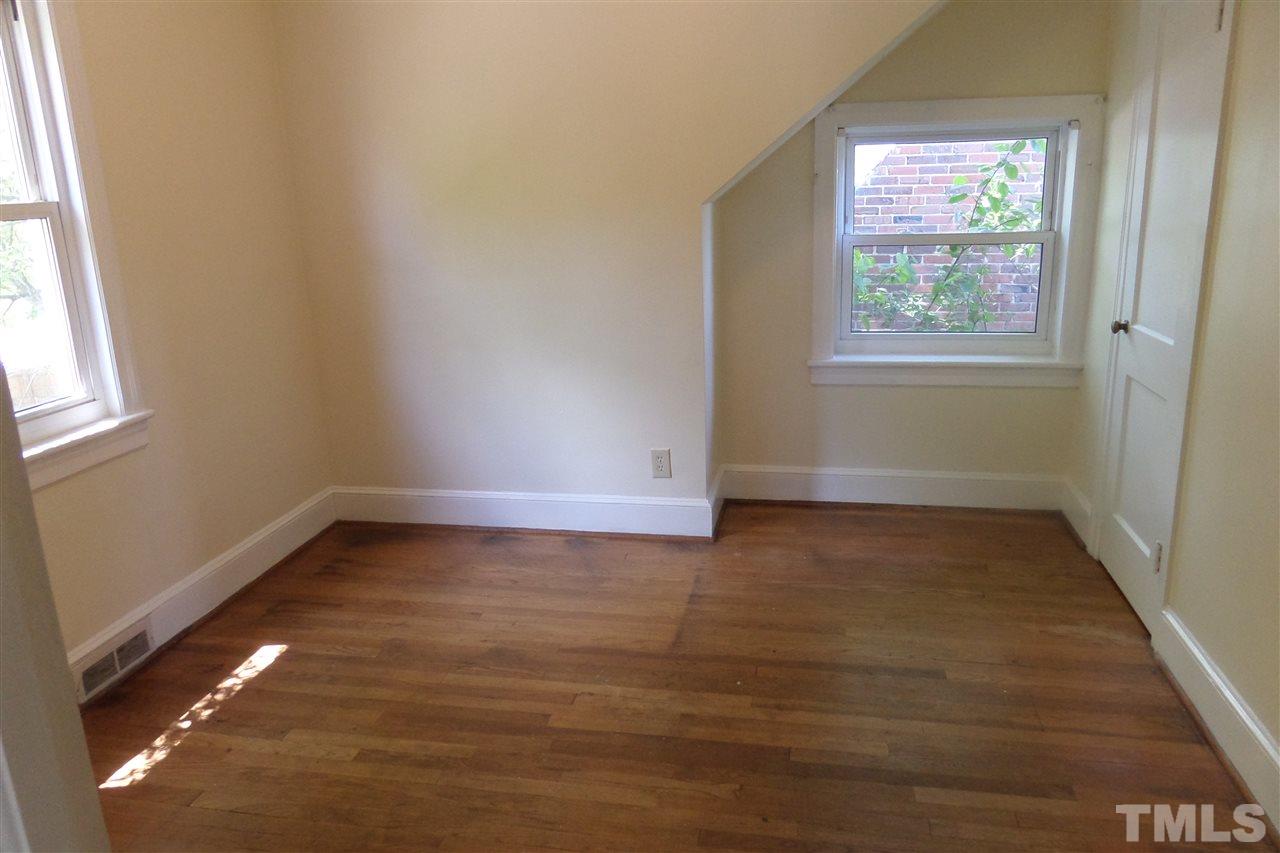 1102 East Martin Street Raleigh, NC 27610 - Photo 16 of 21 an empty room with wooden floor and windows