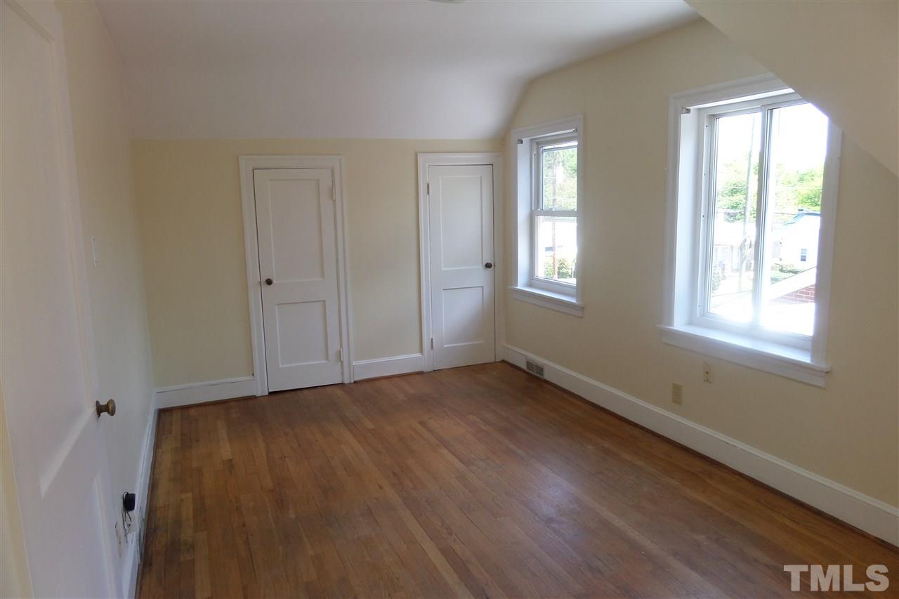 1102 East Martin Street Raleigh, NC 27610 - Photo 17 of 21 a view of an empty room with wooden floor and window