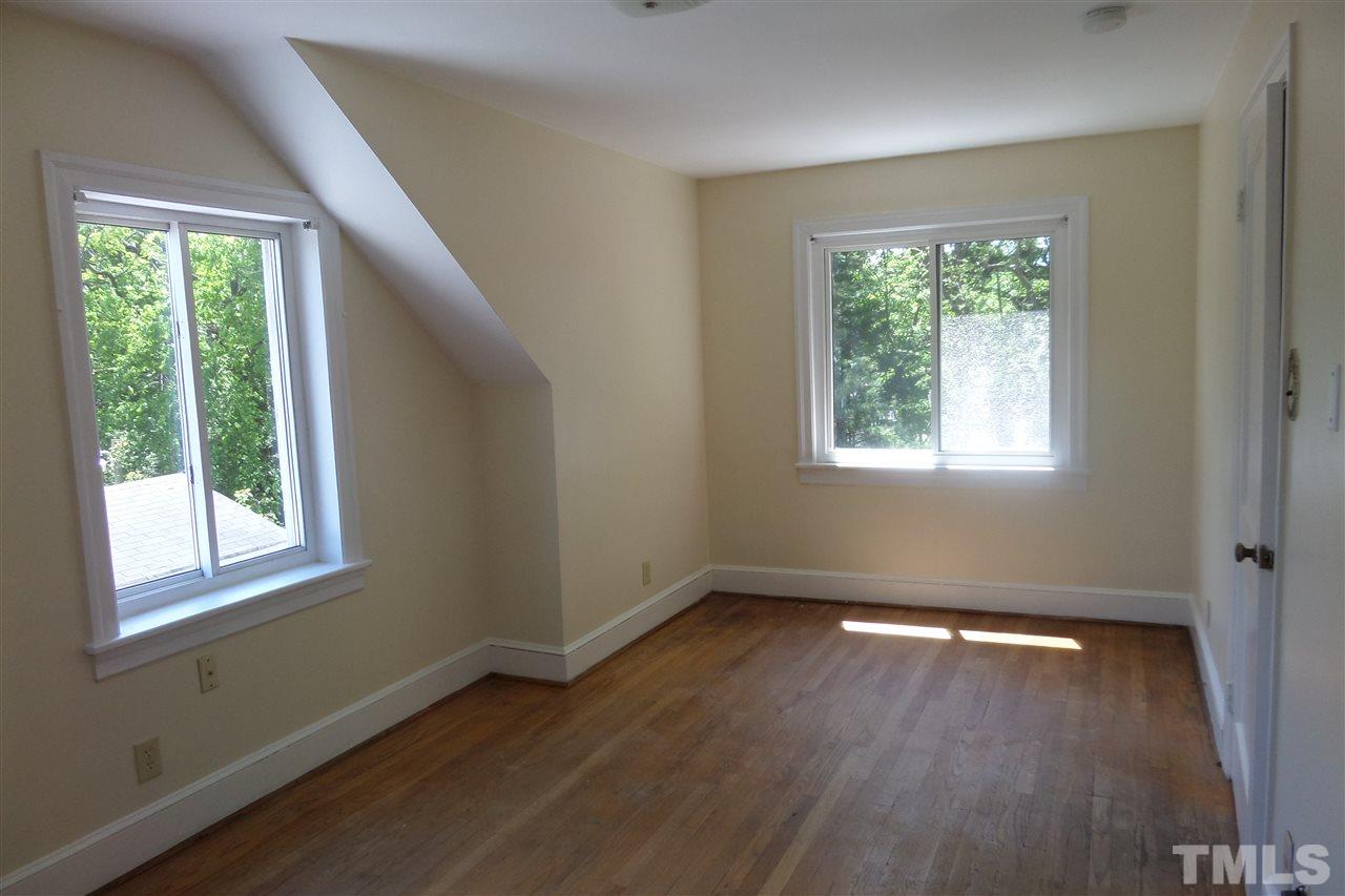 1102 East Martin Street Raleigh, NC 27610 - Photo 18 of 21 a view of an empty room with wooden floor and a window