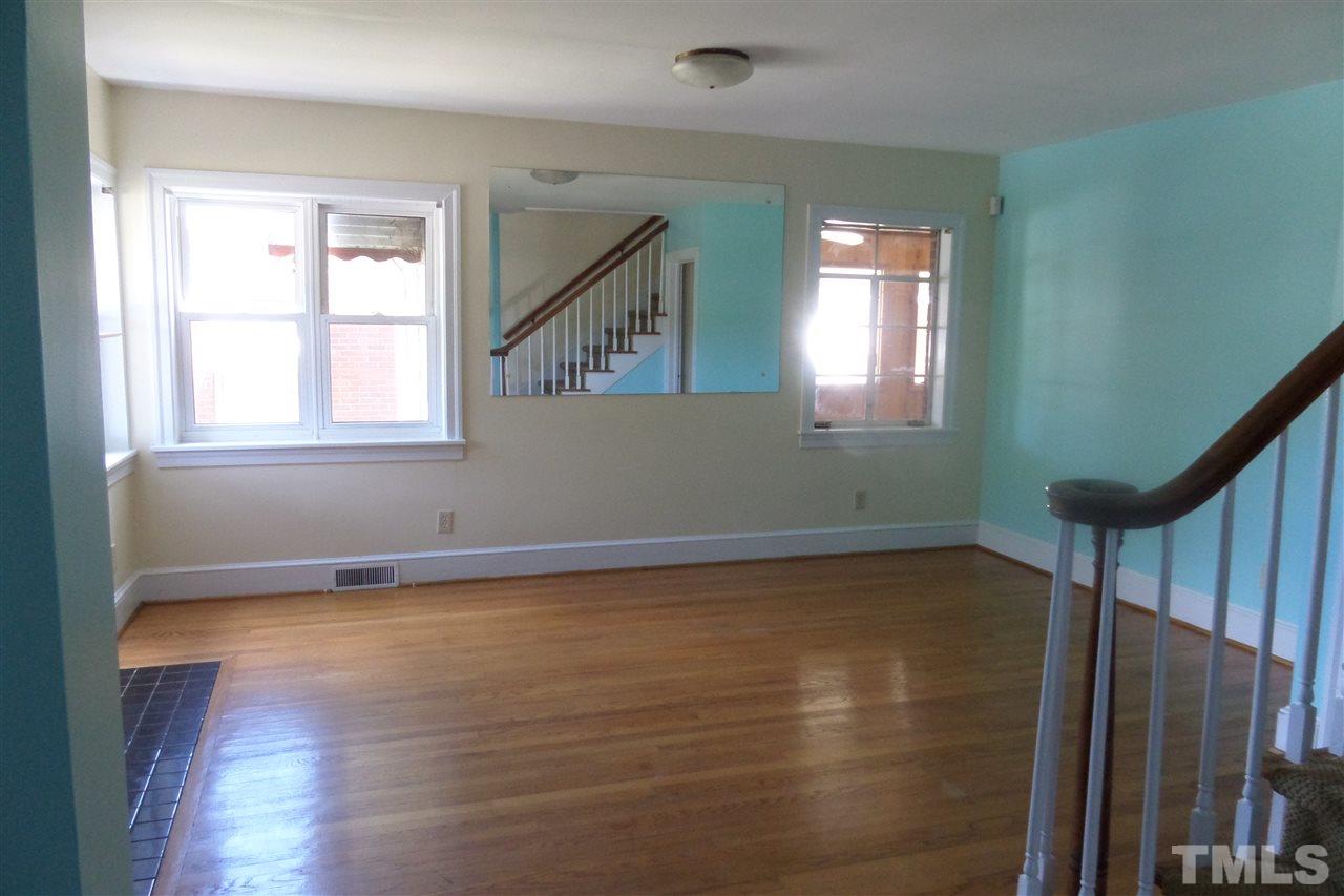 1102 East Martin Street Raleigh, NC 27610 - Photo 6 of 21 a view of an empty room with wooden floor and a window