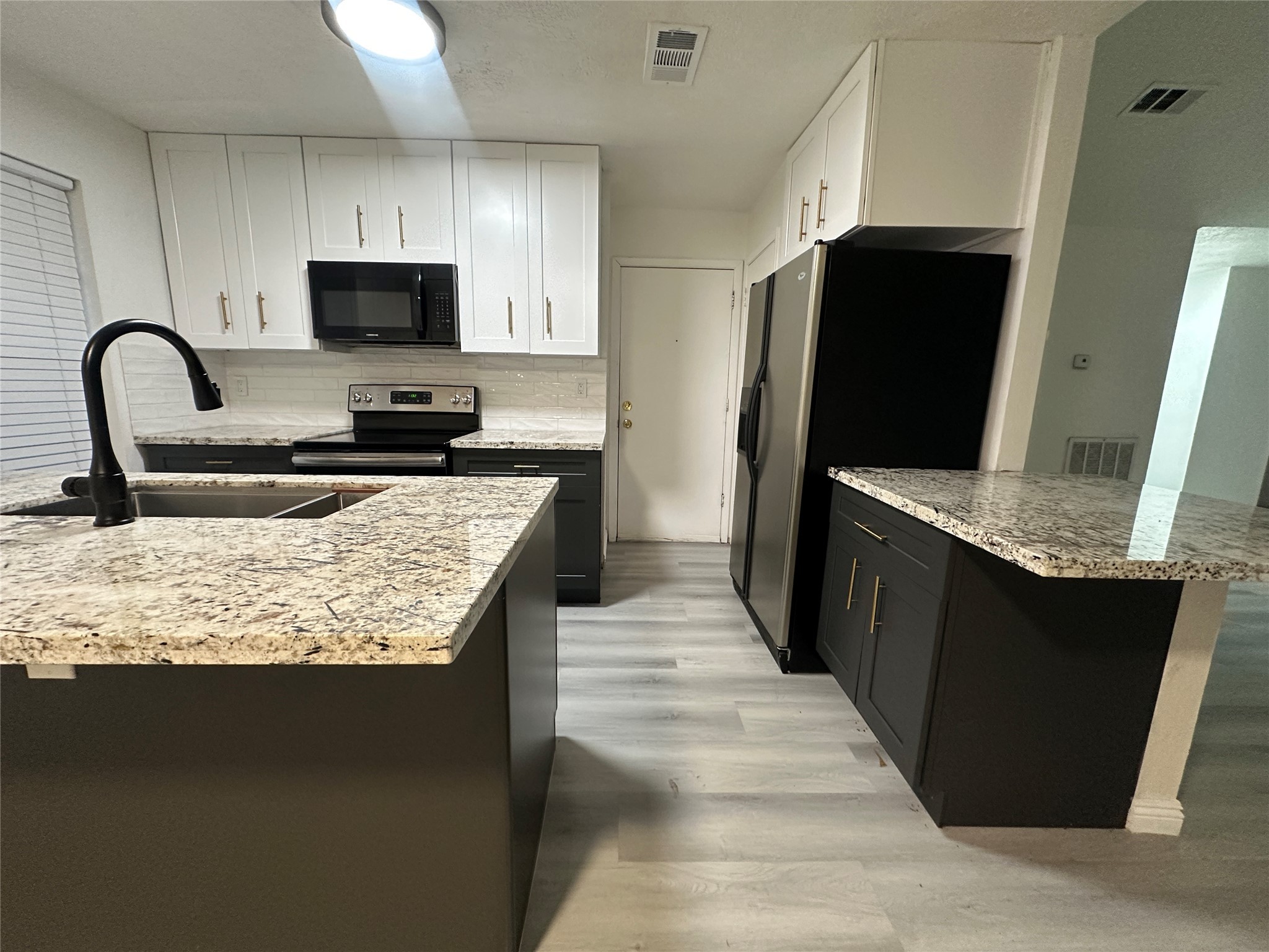 5726 Yorkgate Drive Spring, TX 77373 - Photo 1 of 22 a kitchen with granite countertop a refrigerator and a sink