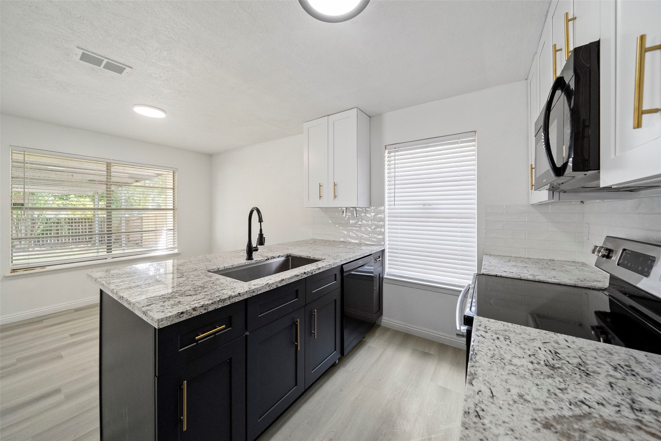 5726 Yorkgate Drive Spring, TX 77373 - Photo 11 of 22 a kitchen with a sink stove and cabinets