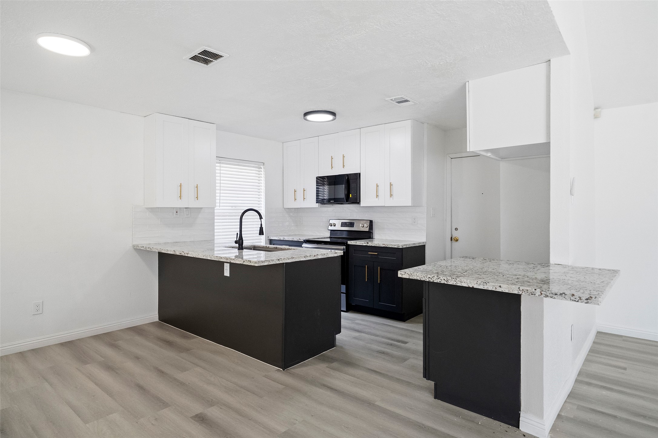 5726 Yorkgate Drive Spring, TX 77373 - Photo 12 of 22 a kitchen with granite countertop a sink cabinets and stainless steel appliances