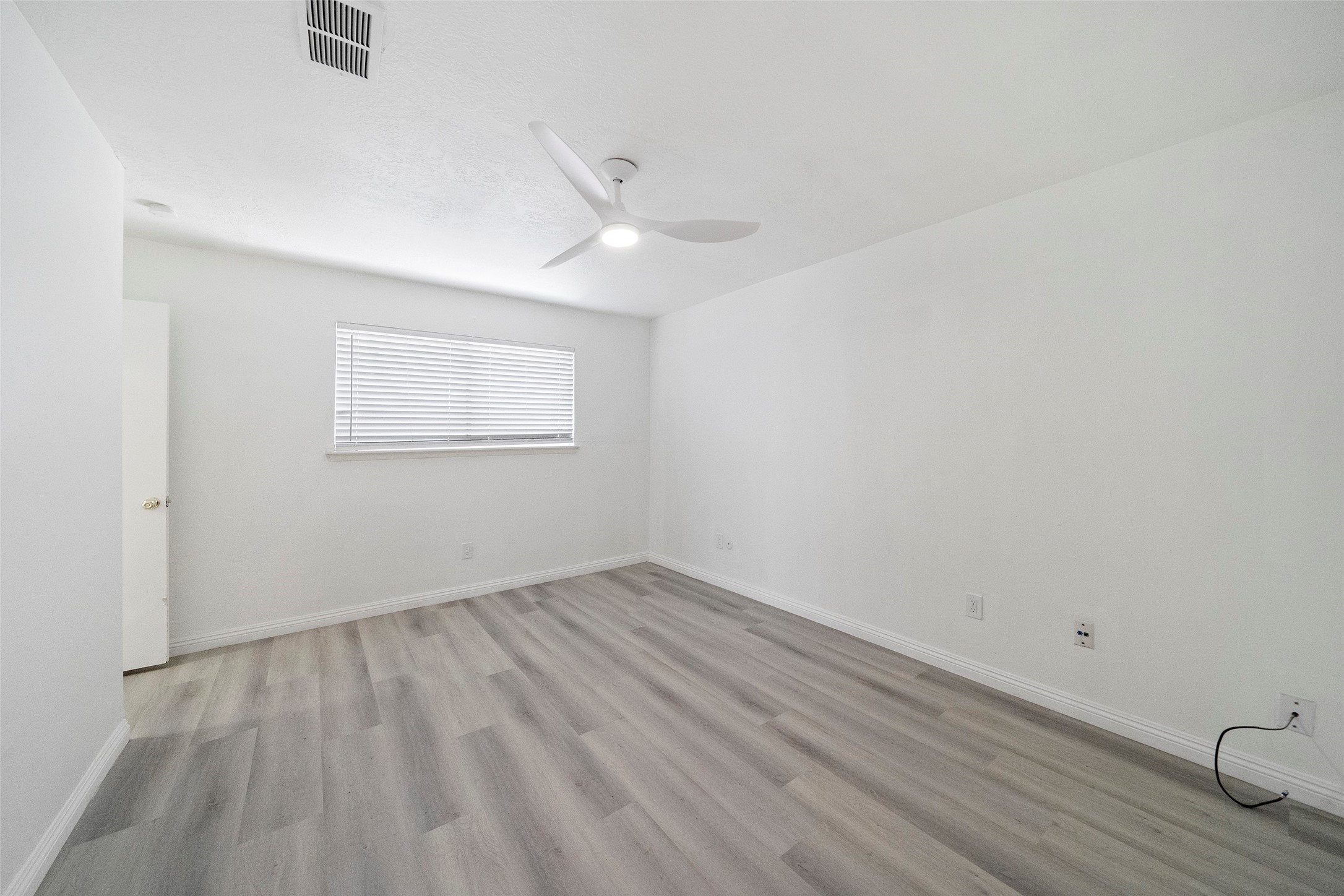 5726 Yorkgate Drive Spring, TX 77373 - Photo 13 of 22 an empty room with wooden floor and windows