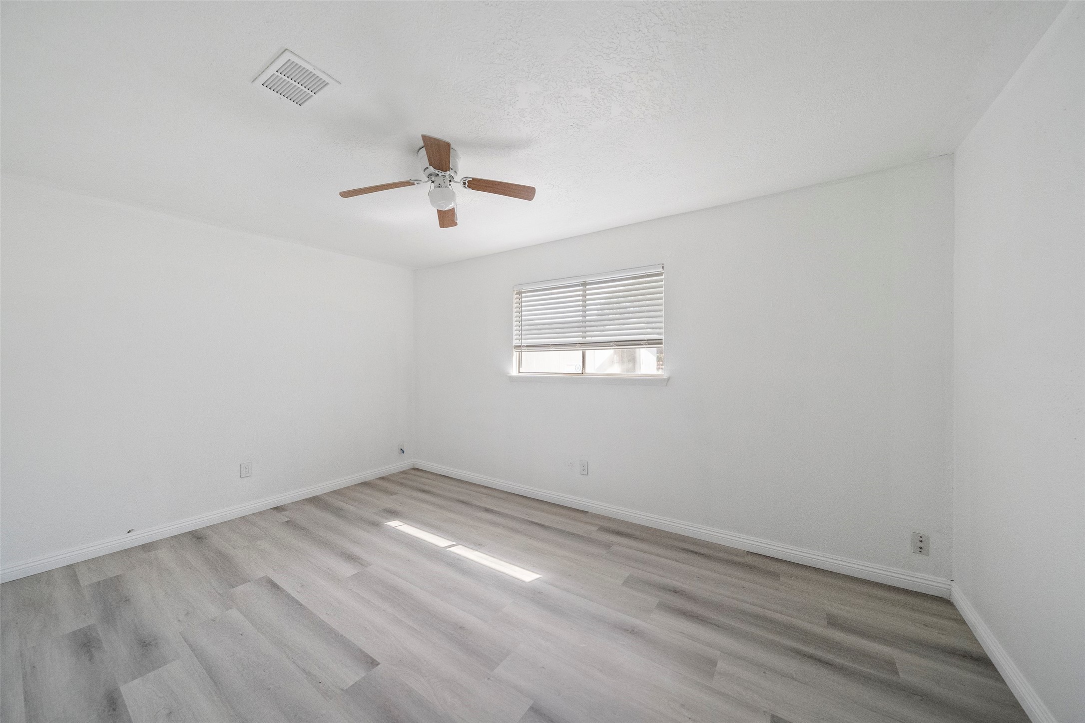 5726 Yorkgate Drive Spring, TX 77373 - Photo 17 of 22 wooden floor in an empty room with a window