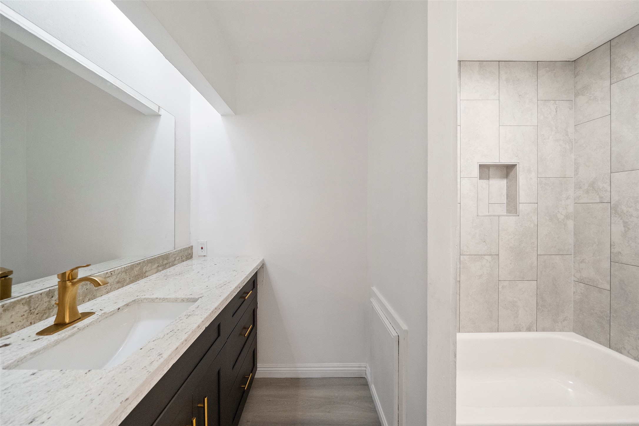 5726 Yorkgate Drive Spring, TX 77373 - Photo 18 of 22 a bathroom with a granite countertop sink and a bathtub