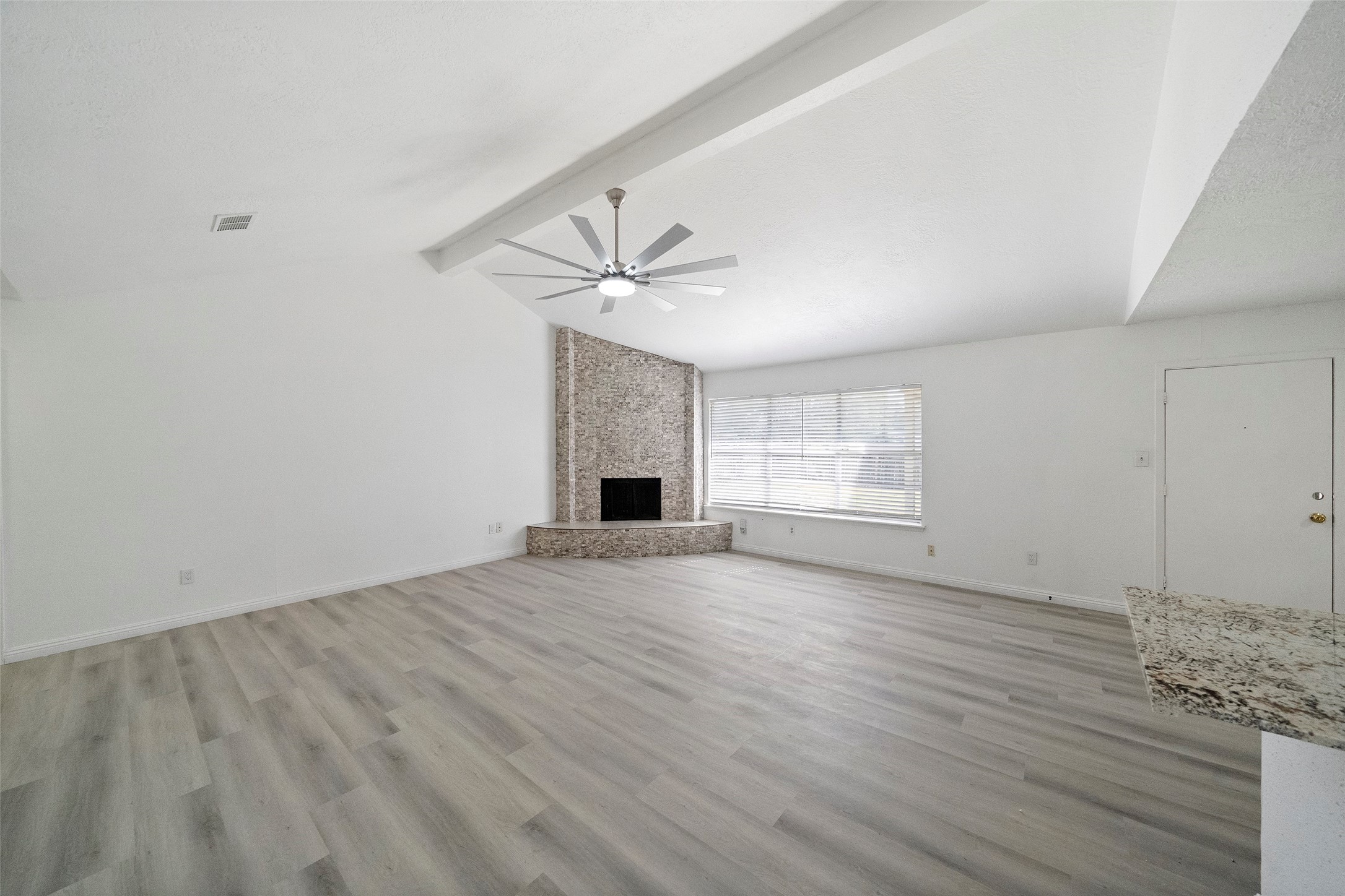 5726 Yorkgate Drive Spring, TX 77373 - Photo 5 of 22 a view of an empty room with wooden floor and a window