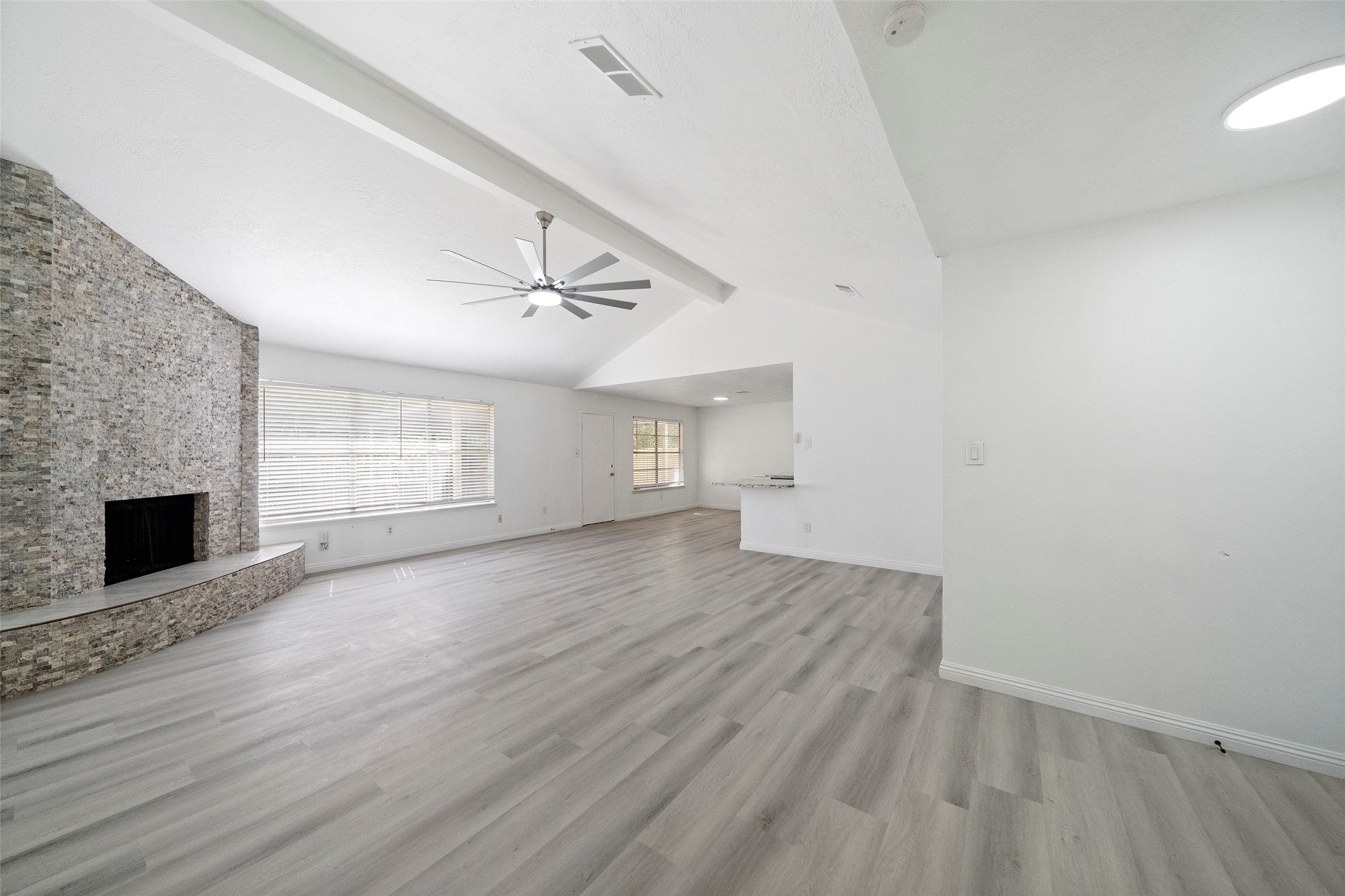 5726 Yorkgate Drive Spring, TX 77373 - Photo 6 of 22 an empty room with wooden floor fireplace and windows
