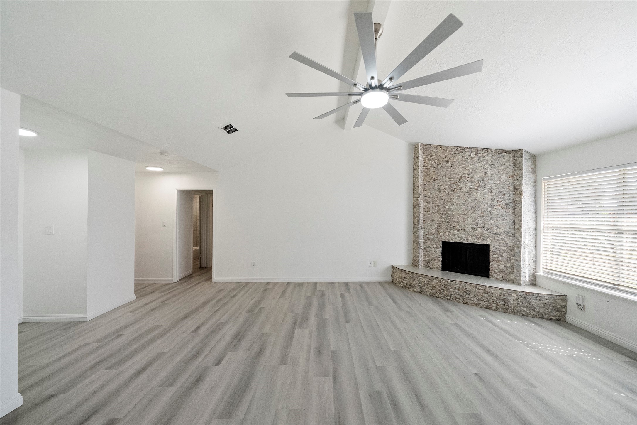5726 Yorkgate Drive Spring, TX 77373 - Photo 7 of 22 an empty room with windows and a fireplace